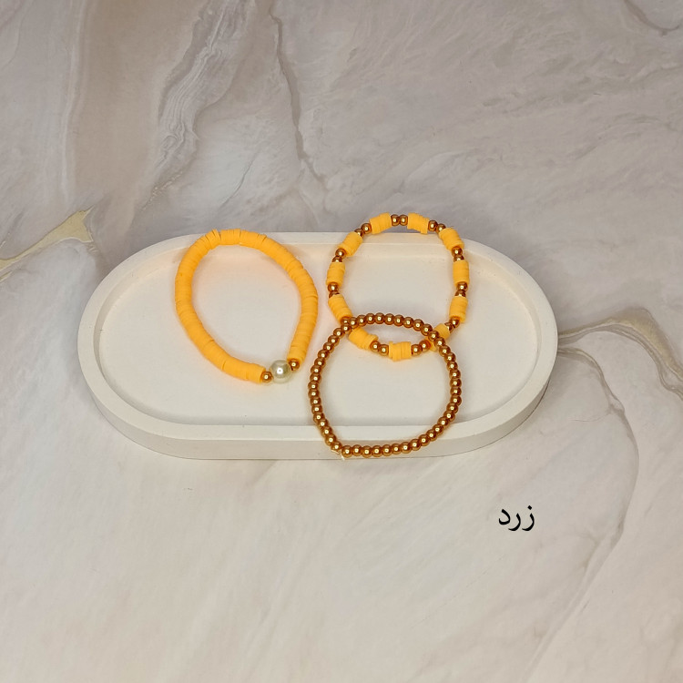 دستبند سه تایی فیمو واشری و مروارید زرد رنگ با مهره های طلایی