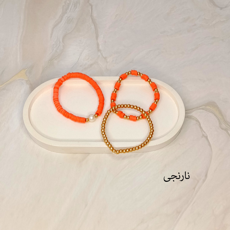 دستبند سه تایی فیمو واشری و مروارید نارنجی رنگ با مهره های طلایی